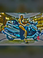 photo from the publication "EICMA 2012", author Andrea Gianotti, Tags: [exhibitions, shoes black, Italy, black dress, high slit, Milan, dress long, sitting legs crossed, high heels, events, sitting sideways on a motorcycle, , , Europe]