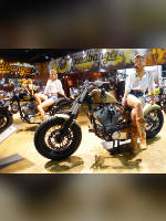 photo from the publication "EICMA 2012", author Andrea Gianotti, Tags: [exhibitions, short shorts, denim shorts, boots below the knee, blouse white, Italy, tight shorts, Milan, naked legs, events, sitting sideways on a motorcycle, , , Europe]